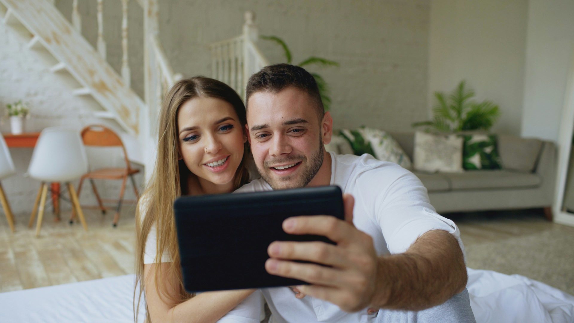 Couple taking a selfie with a tablet